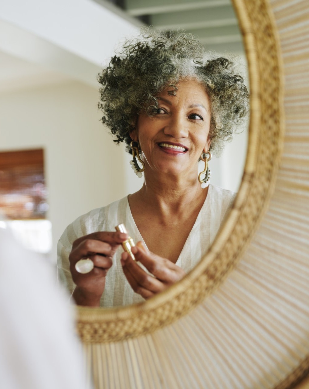 Older woman looking in mirror
